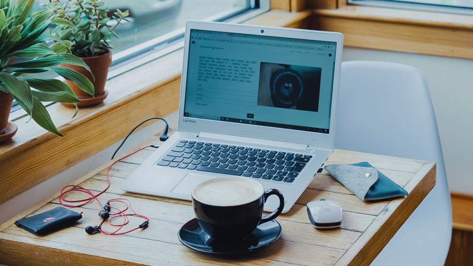 laptop sobre un escritorio con una taza de café